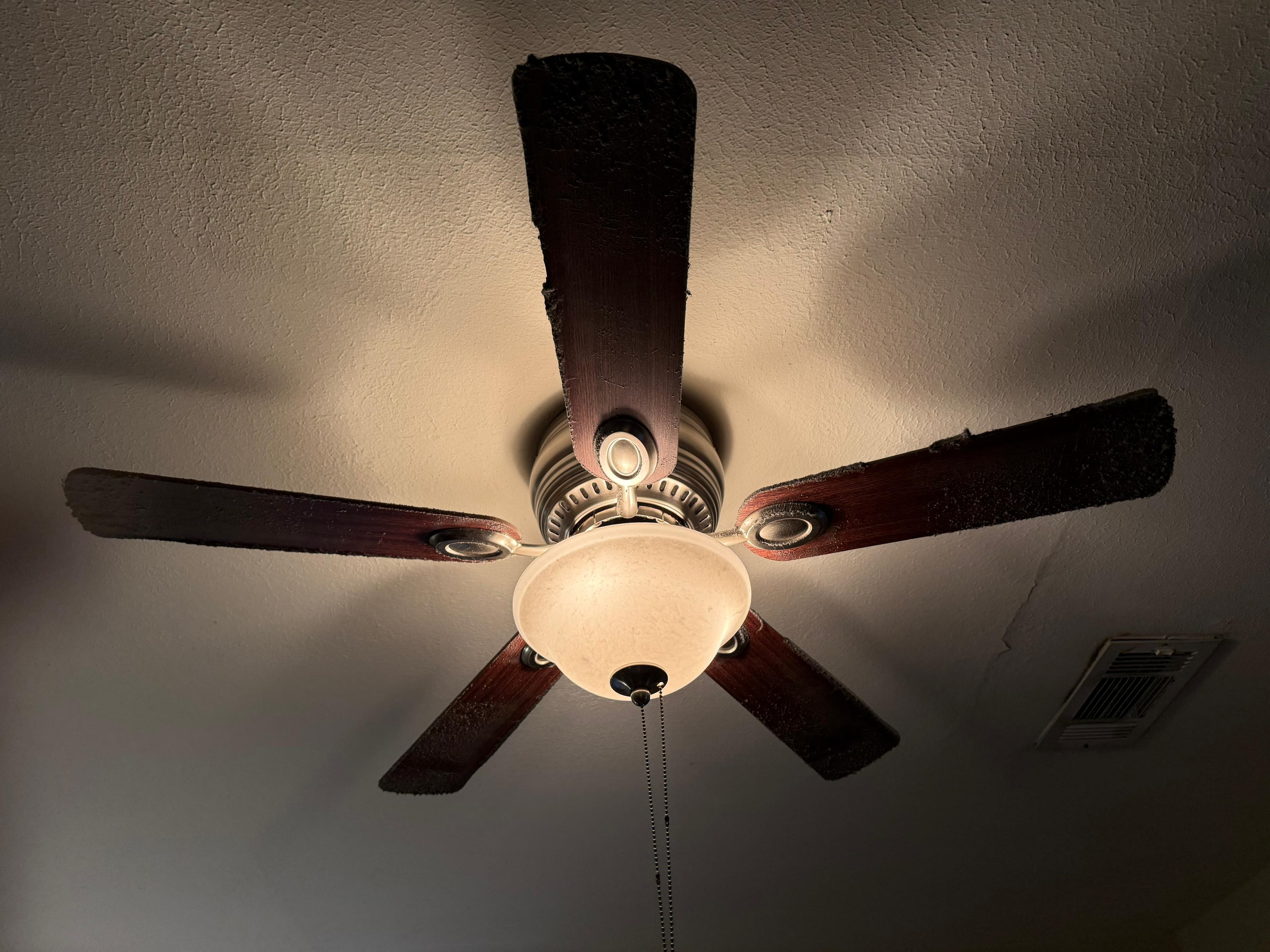 Ceiling fan with visible dust buildup before cleaning